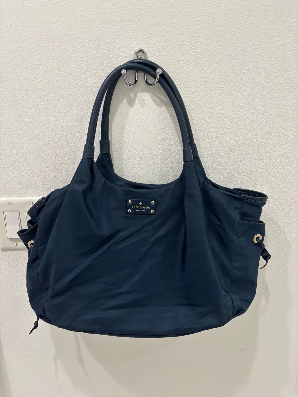 kate spade navy blue tote with gold logo plaque